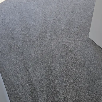 Grey carpet showing the passes of the cleaning wand
